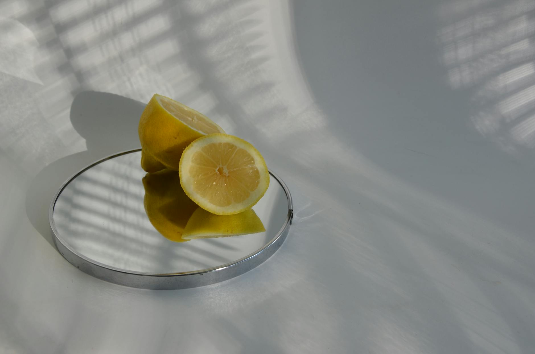 Vibrant ripe lemons composed on a bright yellow background, representing renewal and sensory awakening.
