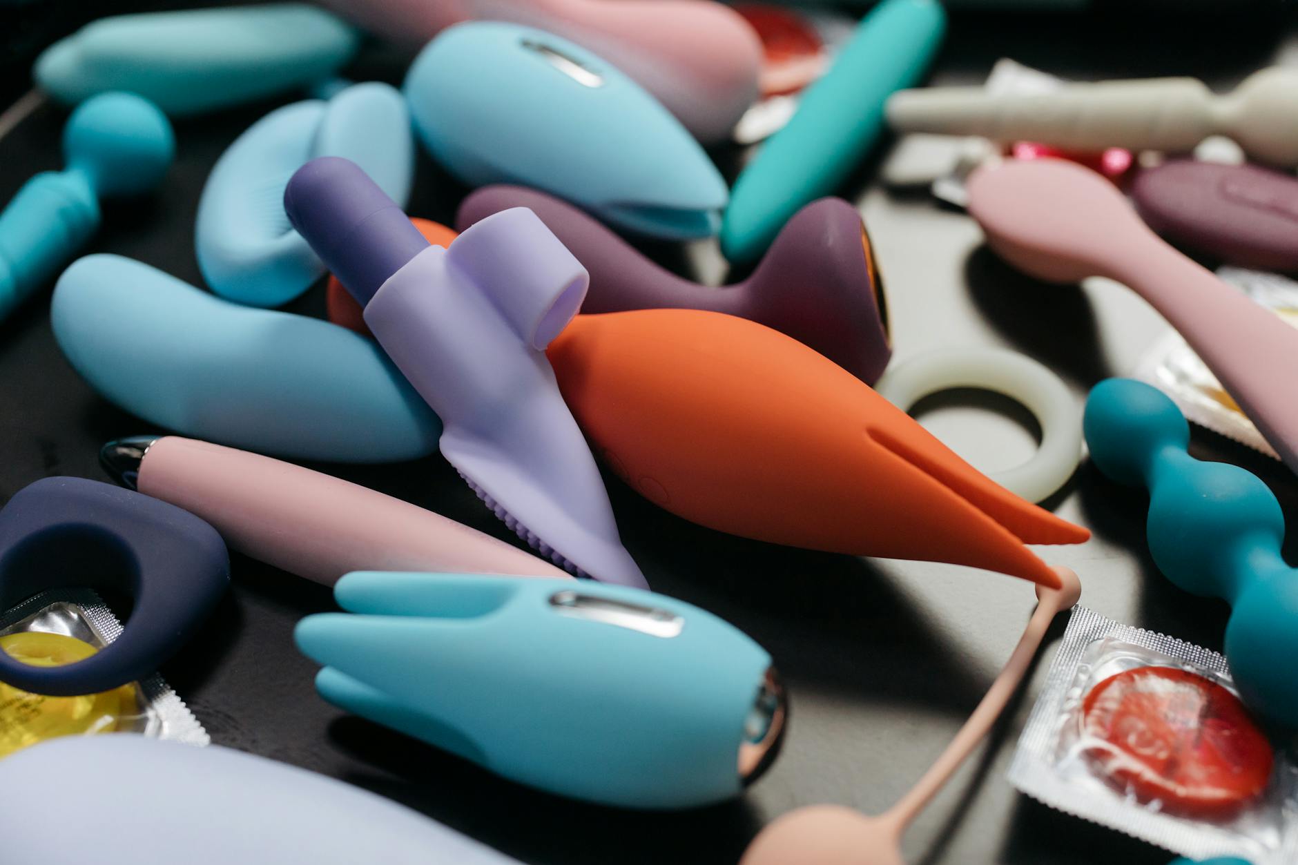 An array of vibrant adult toys including lemon vibrators and rings displayed in close-up.