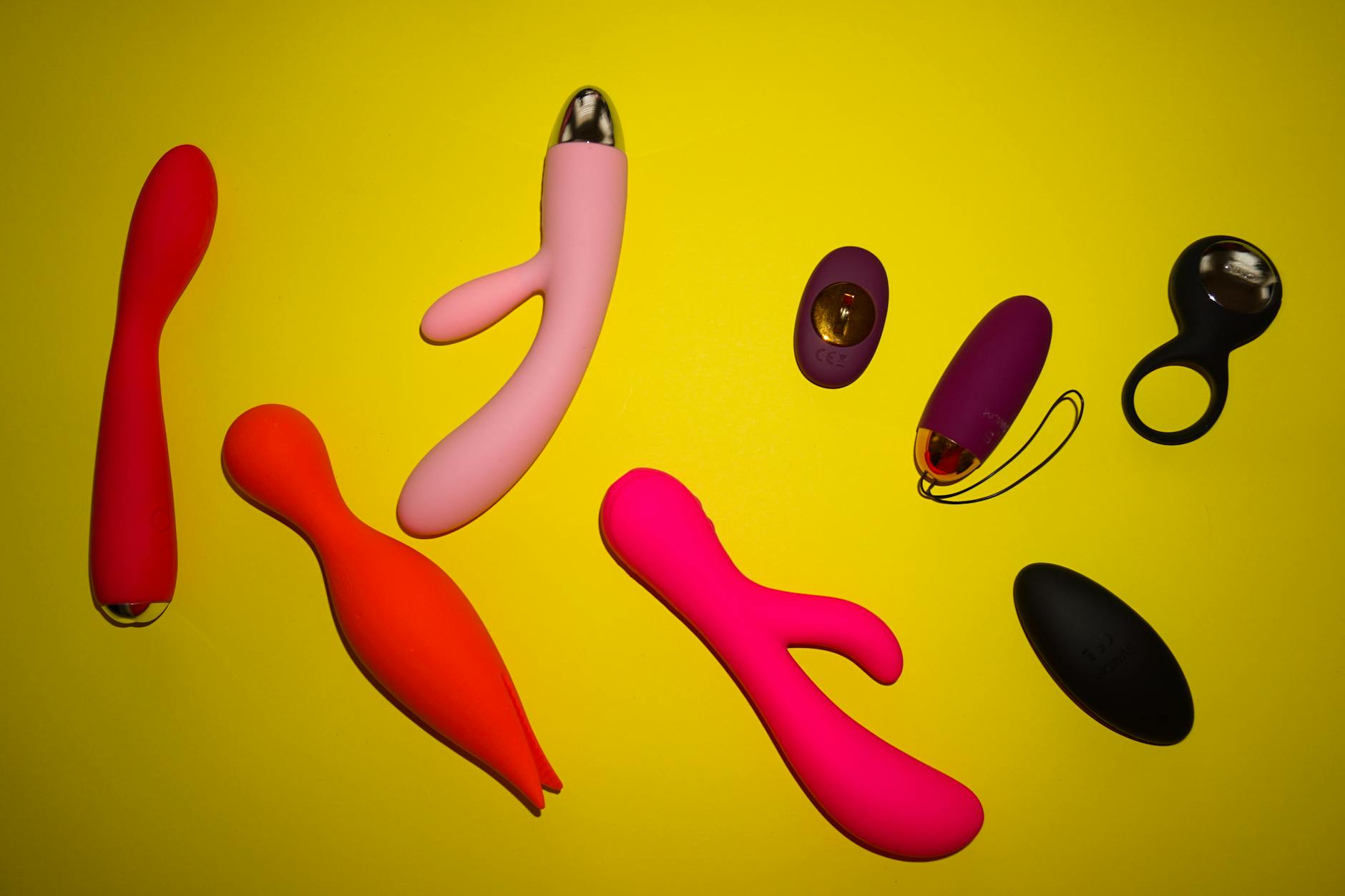 Colorful arrangement of flowers and abstract objects on a bright yellow background