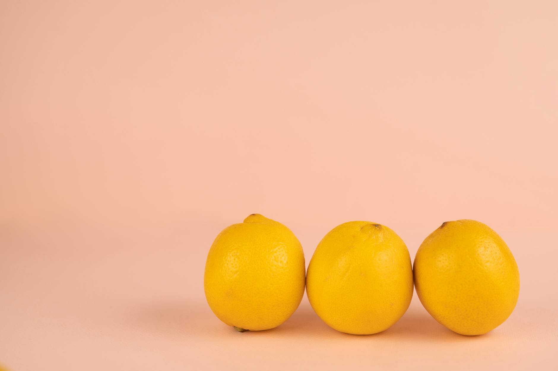 Bright ripe lemons arranged on a pastel background, symbolizing intensified sensation and heightened pleasure